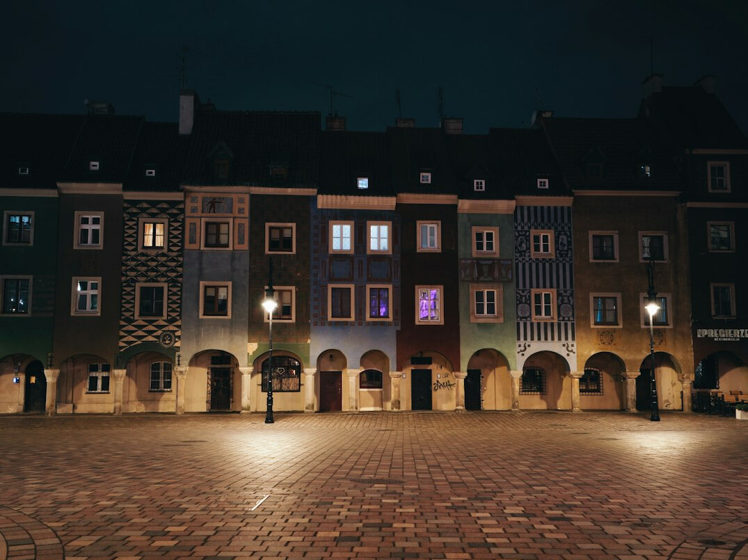 Historic European old town square with colorful townhouses in the evening